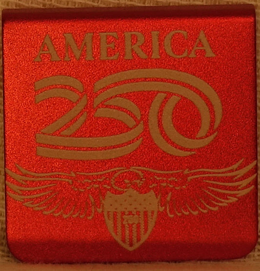 A square 1.25 aluminum hat clip featuring  a lasered hand drawn eagle with the word 'AMERICA' and the number '250'.  The clip has round corners. 