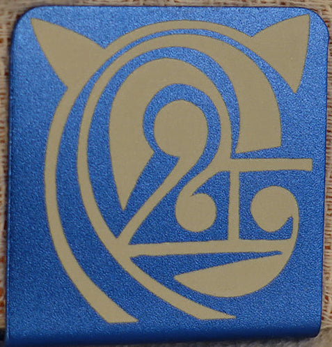 A 1.25" square blue aluminum hat clip with round corners and a geometric laser  doodle deisgn that resembles a cat 